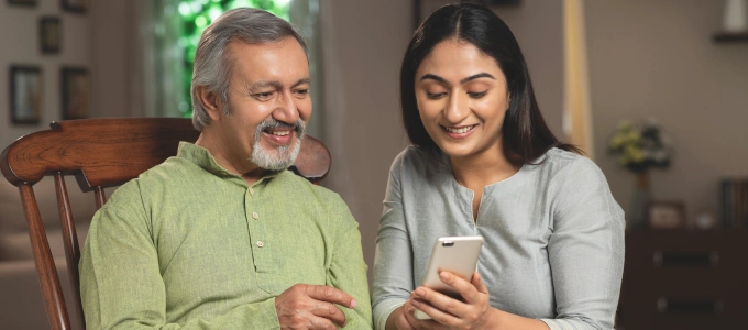 woman showing senior how to use wellness call check-in service