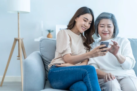 daughter showing her Mom their new wellcheck checkin service